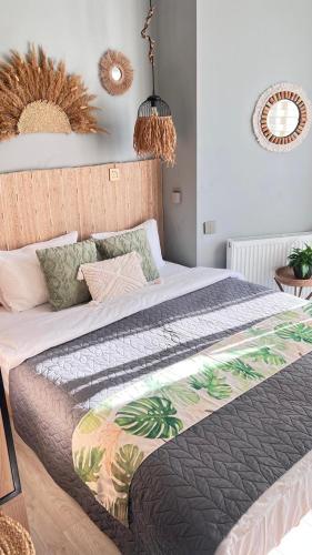 a bedroom with a bed with a comforter on it at Boho apartment studio in Batumi