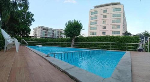 a swimming pool in front of a building at The Living-Hills in Chiang Mai