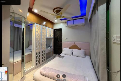 Hotel The Manha LTD Purana Paltan في داكا: غرفة نوم صغيرة بها سرير وسقف
