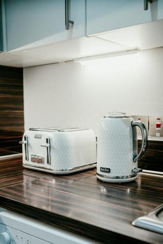 two toasters sitting on top of a kitchen counter at Urban Elegance: Luxury; Sleeps 6 in Belfast