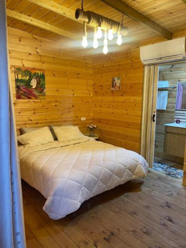 a bedroom with a bed in a wooden wall at Relax Home Nazareth Rawaqan 2026 منتجع روقان צמר נצרת in Nazareth