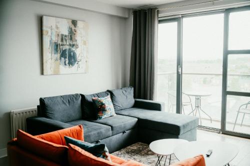 a living room with a couch and a table at Urban Elegance: Luxury; Sleeps 6 in Belfast