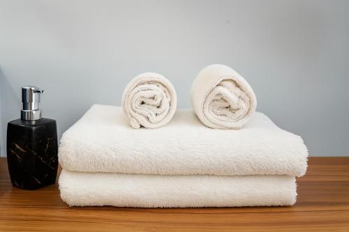 a stack of towels sitting on top of a table at Orange Crystal Phoenix hotel in Bắc Ninh