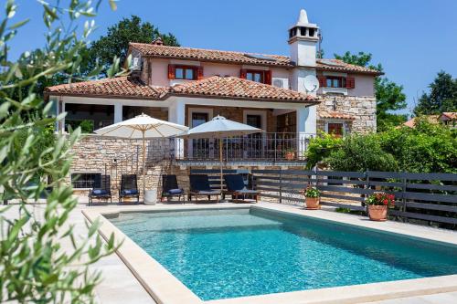 a house with a swimming pool in front of a house at House Matija in Svetvinčenat