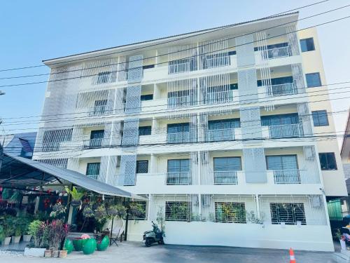 a large white building with many windows at Collection O Room Lanna Hotel in Chiang Mai