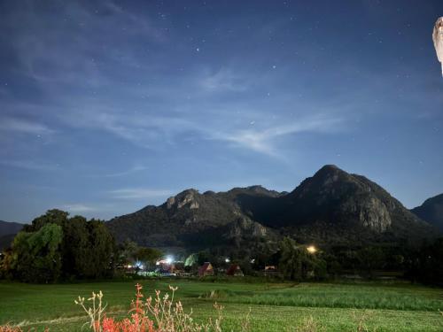 a field at night with mountains in the background at Valle Colibrí in Tuxpan