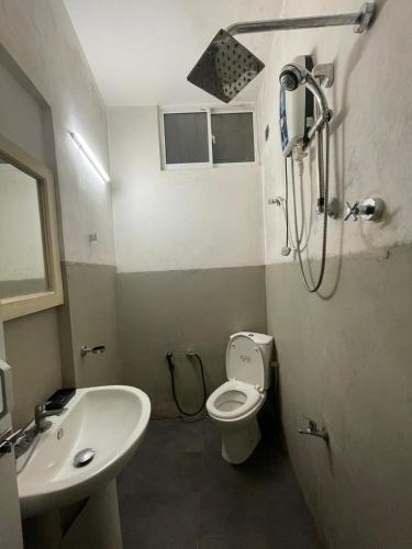a bathroom with a toilet and a sink and a shower at Enderamulla Casual Home in Wattala