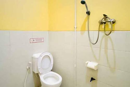 a bathroom with a shower and a toilet in a stall at RedDoorz Syariah near T1 Juanda Airport 2 in Surabaya