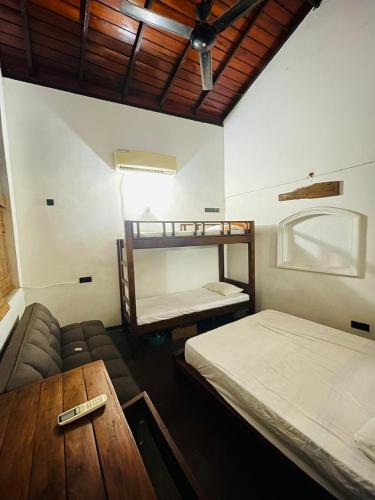 a room with two bunk beds and a table at Enderamulla Casual Home in Wattala