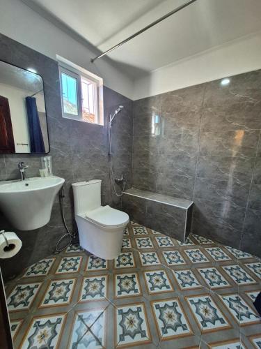 a bathroom with a toilet and a sink and a tub at Kav's Beach Resort in Zamboanguita