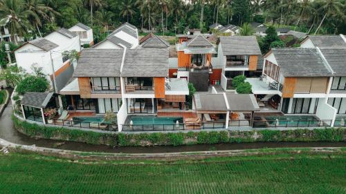an aerial view of a house with houses at Kairos Villa Ubud by Omkara Experience in Ubud