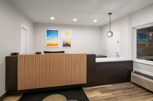 an office with a reception desk and a clock at Days Inn by Wyndham Monterey Downtown in Monterey