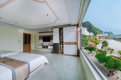a bedroom with a bed and a large window at Seoul Hotel Cat Ba in Cat Ba
