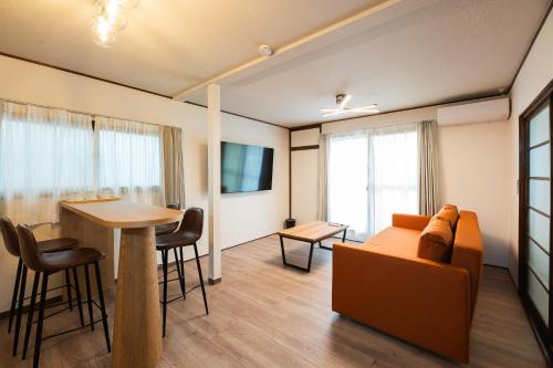 a living room with a couch and a table at Ojanse博多 in Fukuoka