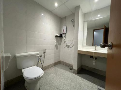 a bathroom with a toilet and a sink at Swing & Pillows - I-City, Shah Alam in Klang