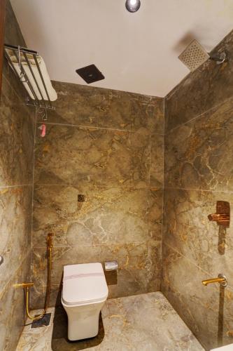 a bathroom with a toilet and a shower at Hotel Isra Comfort Inn in Mumbai