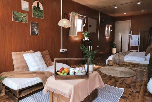 a room with two beds and a table with fruit on it at Xing Retreat & Spa Măng Đen in Kon Plong