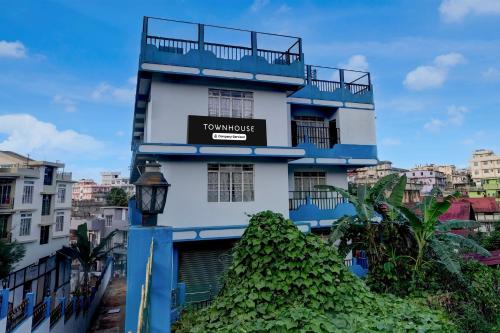 a blue and white building with a sign on it at Townhouse Howell Crossway Shillong Formerly Laban Guest House in Shillong