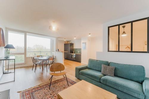 ein Wohnzimmer mit Sofa und Tisch in der Unterkunft Charming apartment 2ch 4p parking and balcony in La Madeleine