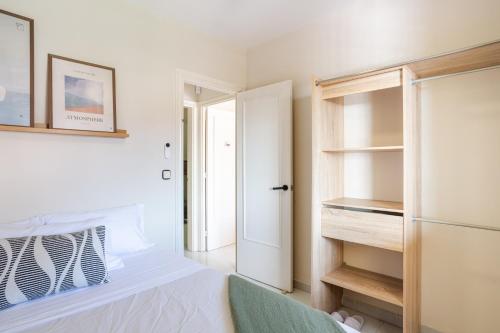 a bedroom with a closet and a refrigerator at Lloret · Villa Gamené piscina y mar in Lloret de Mar
