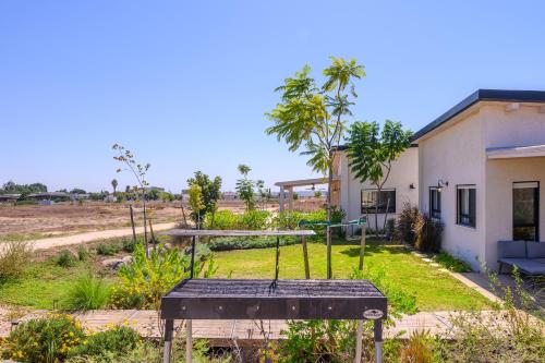 a house with a playground in front of it at צימרים למשפחות, אירוח ~כימים אחדים~ משק אביגור-מקובר in Giv'at Yo'av