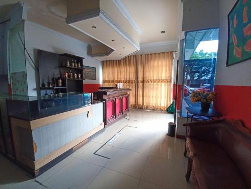 a kitchen with a bar in a restaurant at RedDoorz near Sam Ratulangi Manado in Manado