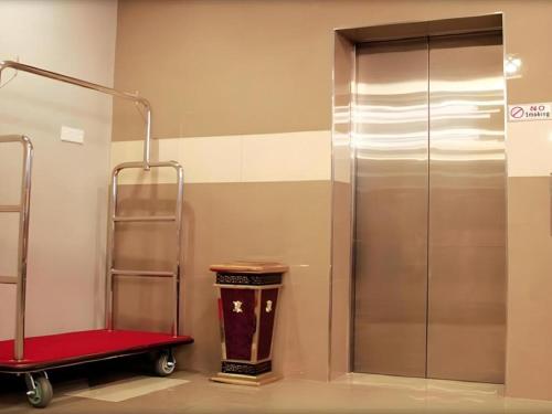 a bathroom with a walk in shower and a trash can at Cukai View Hotel in Kampong Nipah Panjang