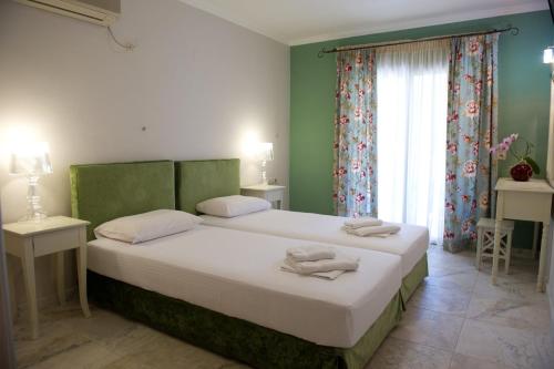 a bedroom with a large bed with towels on it at Akrogiali Studios in Nydri