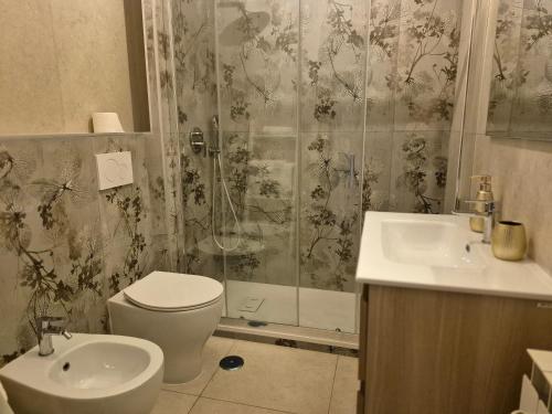 a bathroom with a shower and a toilet and a sink at Elegantia Domina apartment in the center in Fiumicino