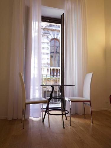 a table and chairs in a room with a window at Stella CasaBono in Sulmona