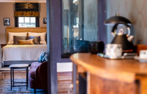 a bedroom with a bed and a table with a lamp at Wilson's Guest House in Wentworth Falls
