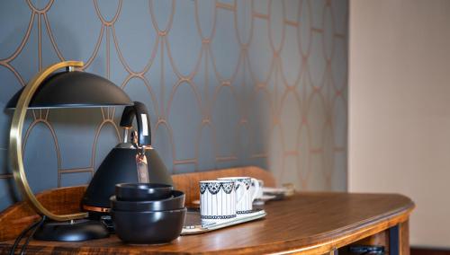 a table with a lamp and a cup on it at Wilson's Guest House in Wentworth Falls