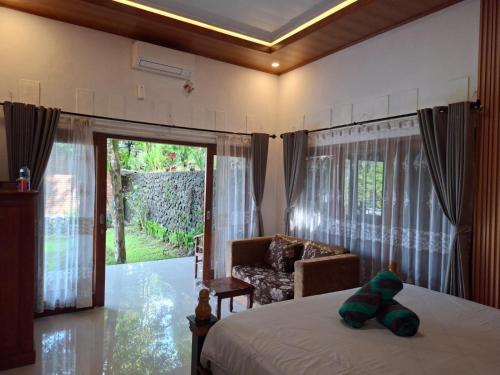 Postel nebo postele na pokoji v ubytování Sekumpul Guest House