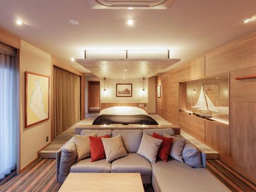 a living room with a couch and a bed at Y-HOTEL - Vacation STAY 22285v in Hiroshima