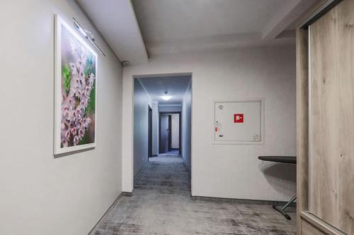 a hallway with white walls and a painting on the wall at Hotel Pod Jedlami in Wisła