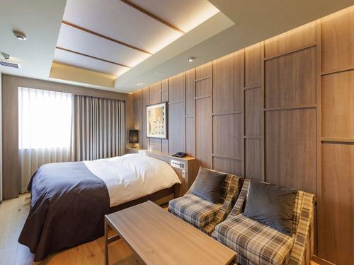 a hotel room with a bed and a couch at Y-HOTEL - Vacation STAY 22328v in Hiroshima