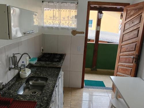 a kitchen with a sink and a counter top at Verde Mar Abricó 4 in Rio das Ostras