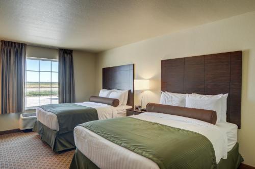 a hotel room with two beds and a window at Cobblestone Inn & Suites - Ord in Ord