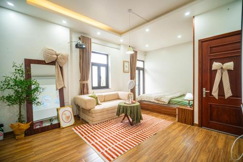 a living room with a couch and a table at Katka Riverside Homestay Hai Phong in An Dương