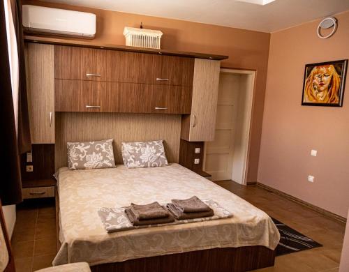 a bedroom with a bed with two towels on it at Guest House Comfort in Montana