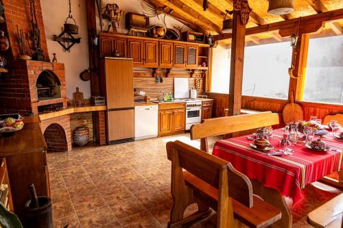 a kitchen with a table with a red table cloth at Guest House Comfort in Montana