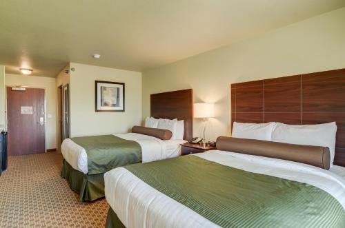 a hotel room with two beds and a room with two at Cobblestone Inn & Suites - Ord in Ord