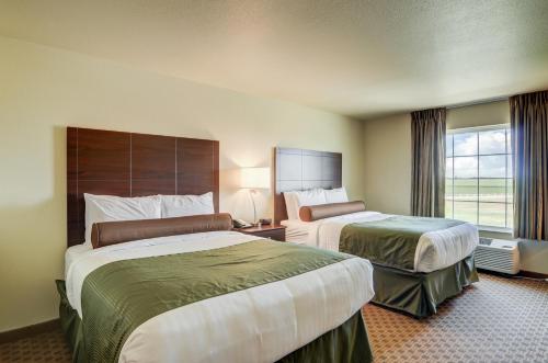 a hotel room with two beds and a window at Cobblestone Inn & Suites - Ord in Ord