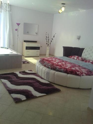 a bedroom with a large bed and a rug at Safi in Dospat