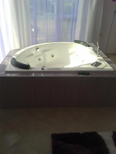 a bath tub in a bathroom with a window at Safi in Dospat