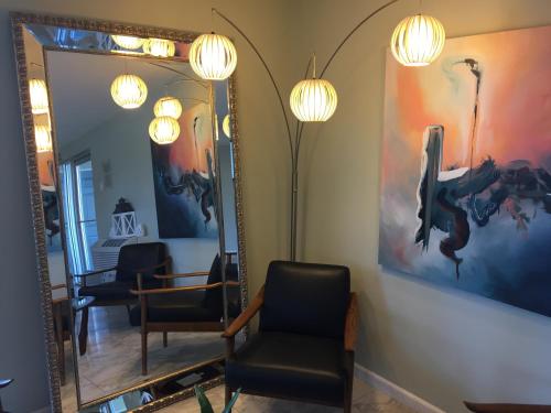 a salon with a mirror and chairs and lights at The Atwood Hotel San Diego - SeaWorld/Zoo in San Diego