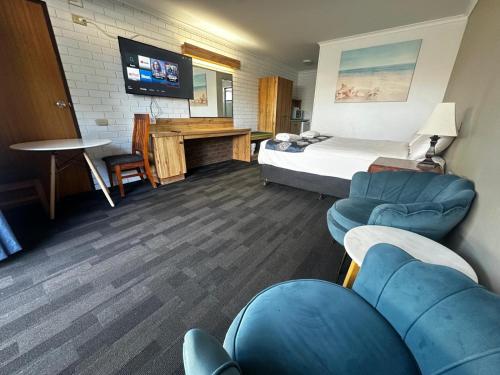 a hotel room with a bed and a desk at Albury Garden Court Motel in Albury