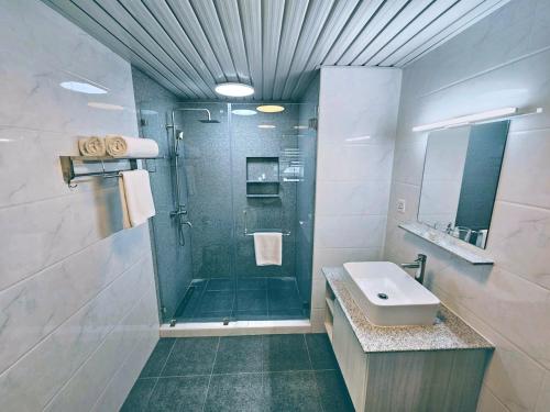 a bathroom with a shower and a sink at La Grande Residence 1BR Corner unit Phase 2-710 in Angeles