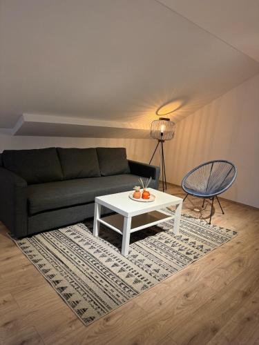 a living room with a couch and a coffee table at Gemütliche 2,5 Zimmer Wohnung in Grenzach-Wyhlen