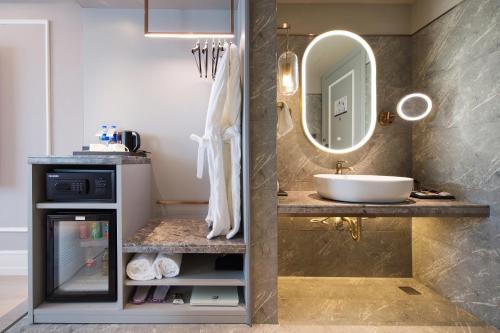 a bathroom with a sink and a mirror at Mercure Harbin Hexing Road in Harbin